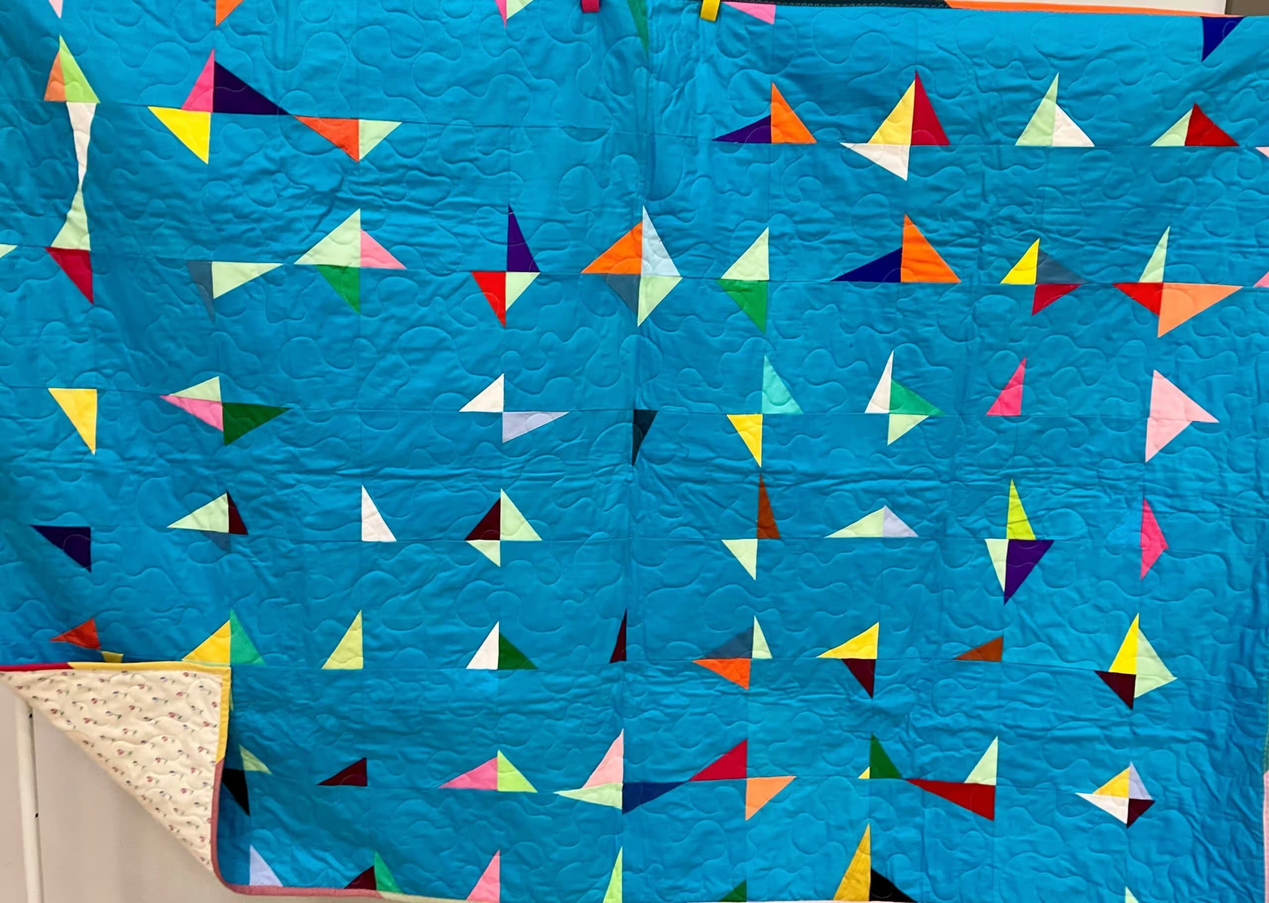 Turquoise with multicolour wonky corners.